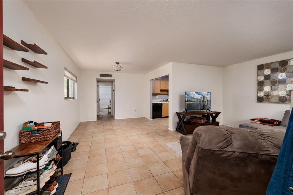 11708 Raintree Village Boulevard, Unit A Temple Terrace, FL 33617 - Photo 6 of 21 a view of a livingroom with furniture and a flat screen tv