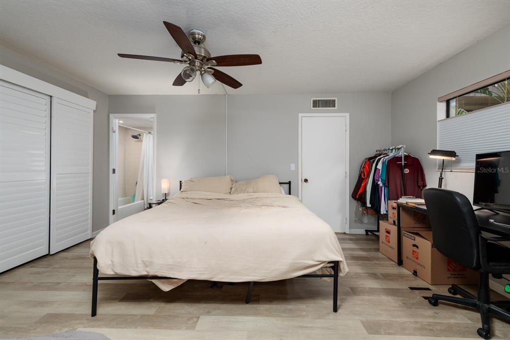 11708 Raintree Village Boulevard, Unit A Temple Terrace, FL 33617 - Photo 10 of 21 a bedroom with a bed and a chair
