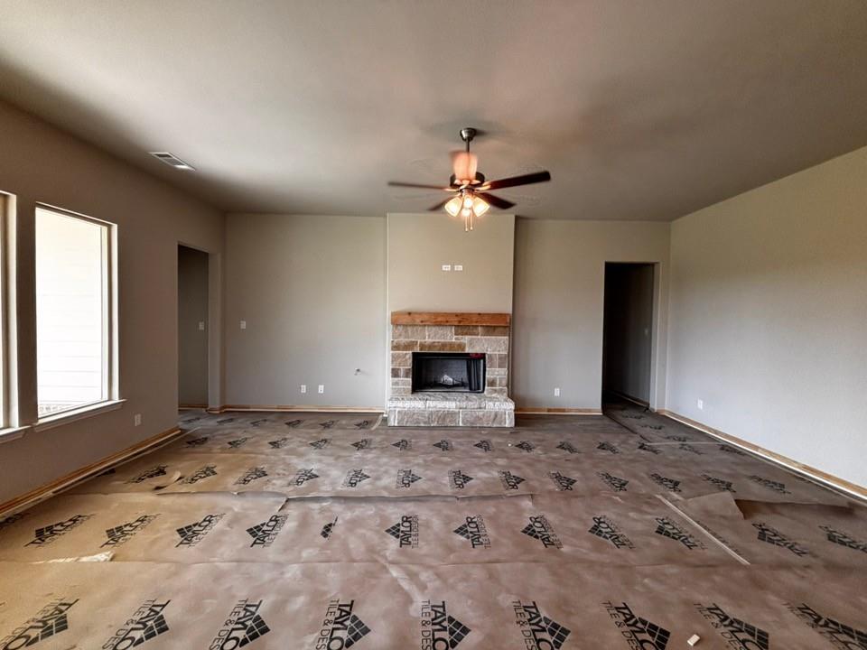 157 Big Sky Road Decatur, TX 76234 - Photo 4 of 13 Stone-clad fireplace with a wood mantel