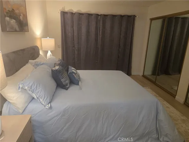 a bedroom with a bed and a night stand