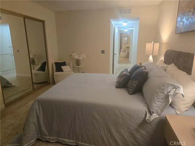 a bedroom with a bed and a mirror