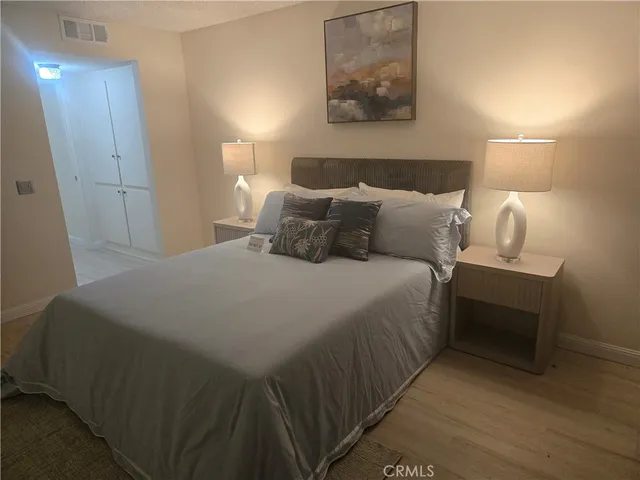 a bed room with a bed and a night stand