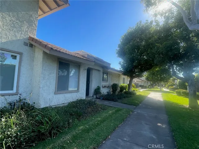 a view of a house with pool and yard