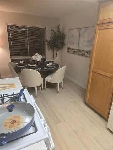 a dining room with furniture and a window