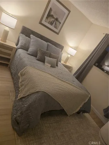 a bed sitting in a bedroom next to a lamp