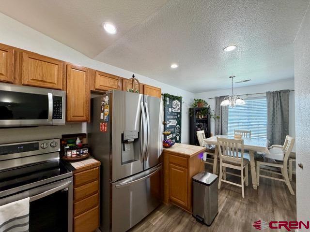 544 20th Street Delta, CO 81416 - Photo 10 of 44 a kitchen with stainless steel appliances kitchen island granite countertop a refrigerator and a stove top oven
