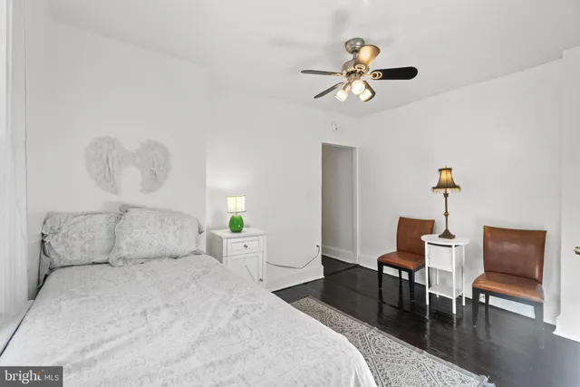 a bedroom with a bed a table and chair