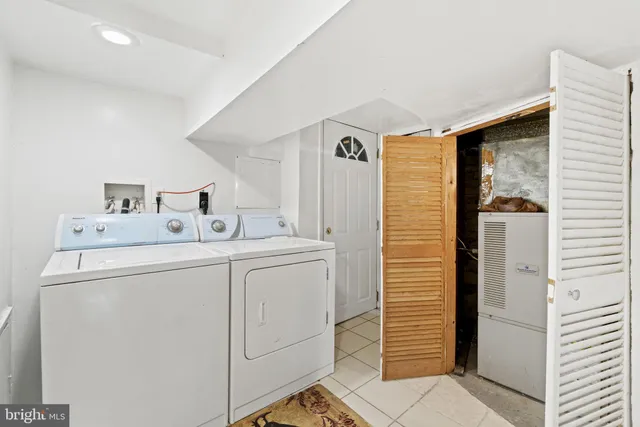 a view of a backyard with chairs potted plants and a wooden fence