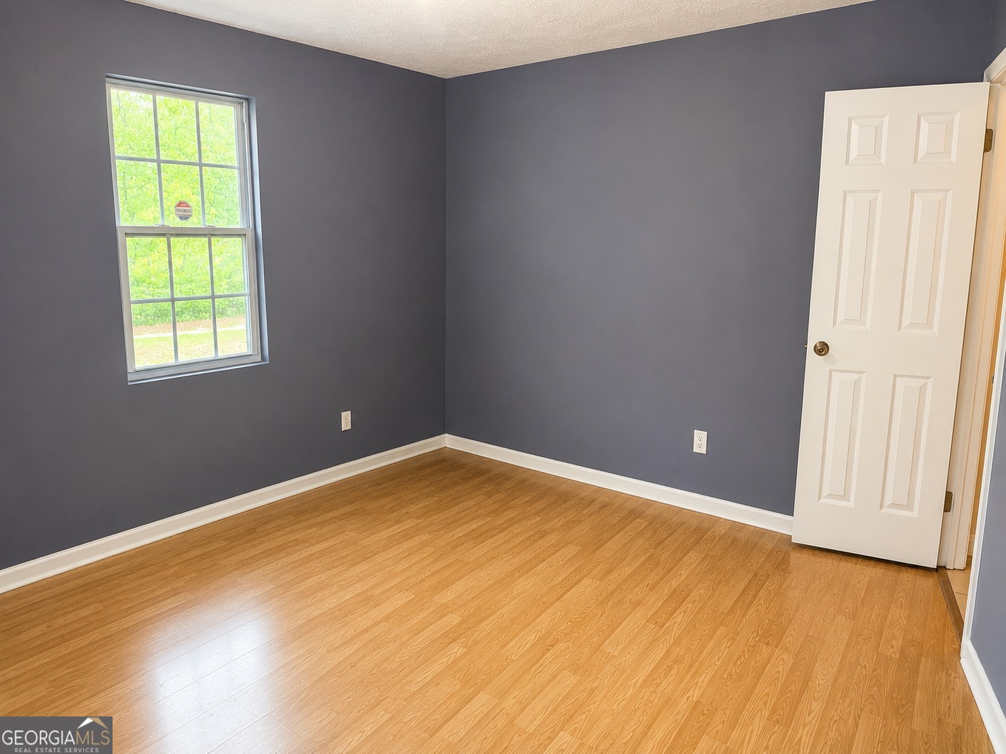 7055 Swift Street Lithonia, GA 30058 - Photo 8 of 9 an empty room with a window