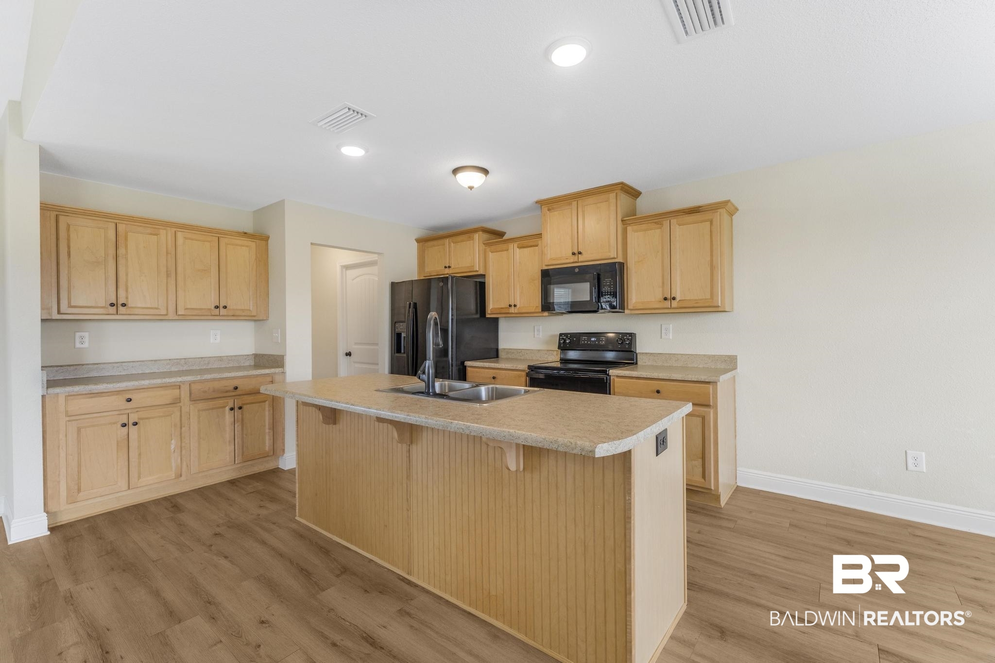 21580 Talbot Lane Robertsdale, AL 36567 - Photo 11 of 25 Kitchen featuring light brown cabinets, a breakfast bar, black appliances, a center island with sink, and recessed lighting