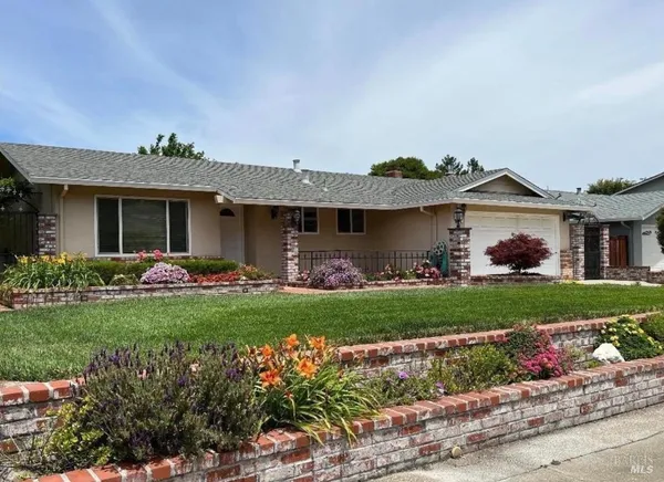 a front view of a house with a garden