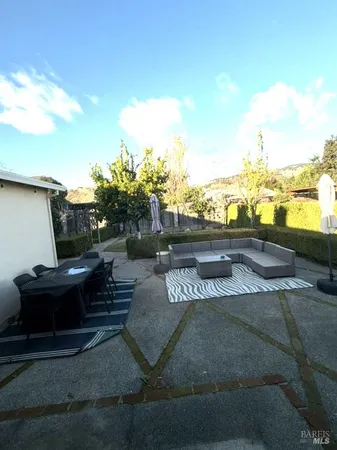 a terrace with outdoor seating and city view