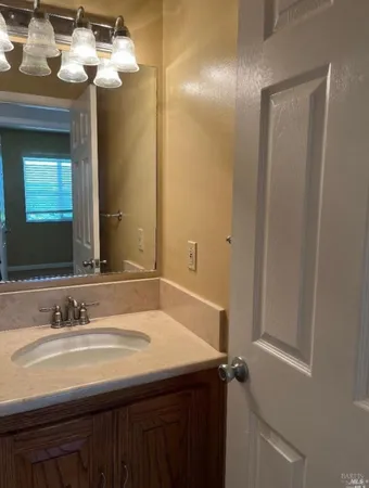 a bathroom with a sink vanity and a mirror