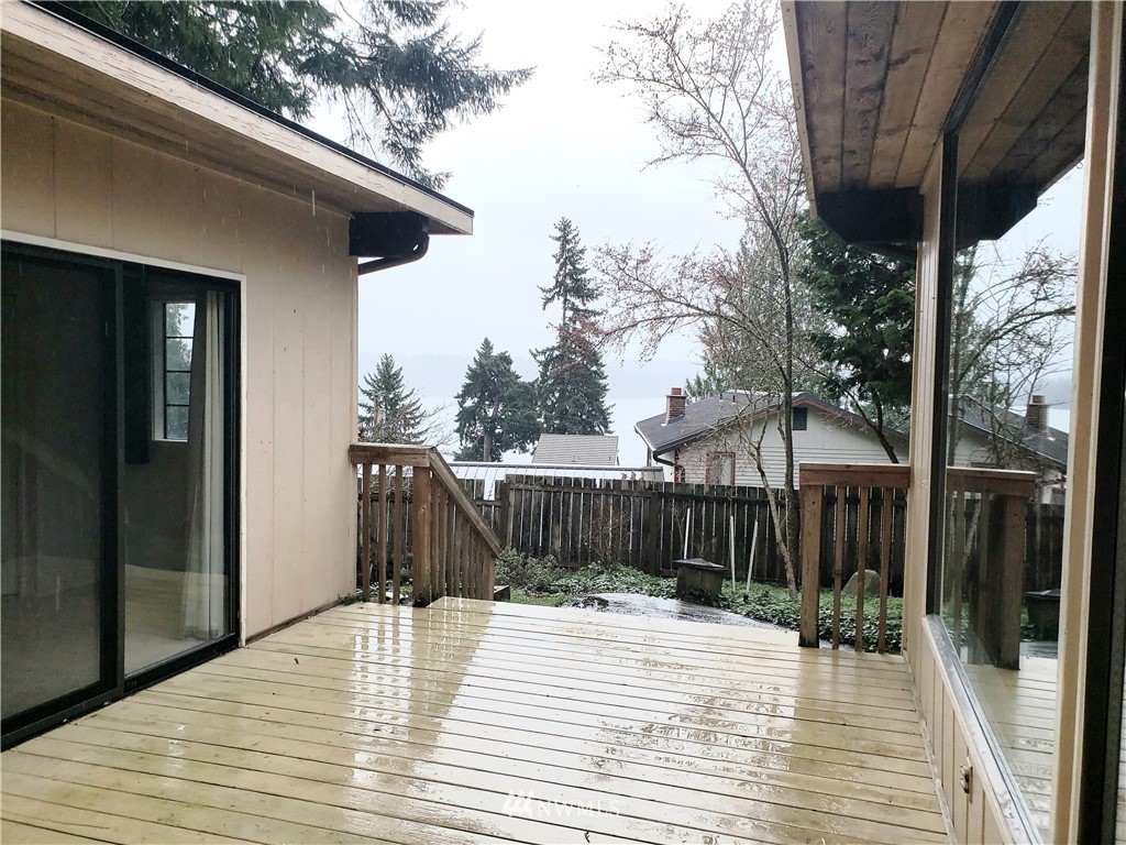 8690 Illahee Road Northeast Bremerton, WA 98311 - Photo 13 of 40 a view of a house with a wooden deck