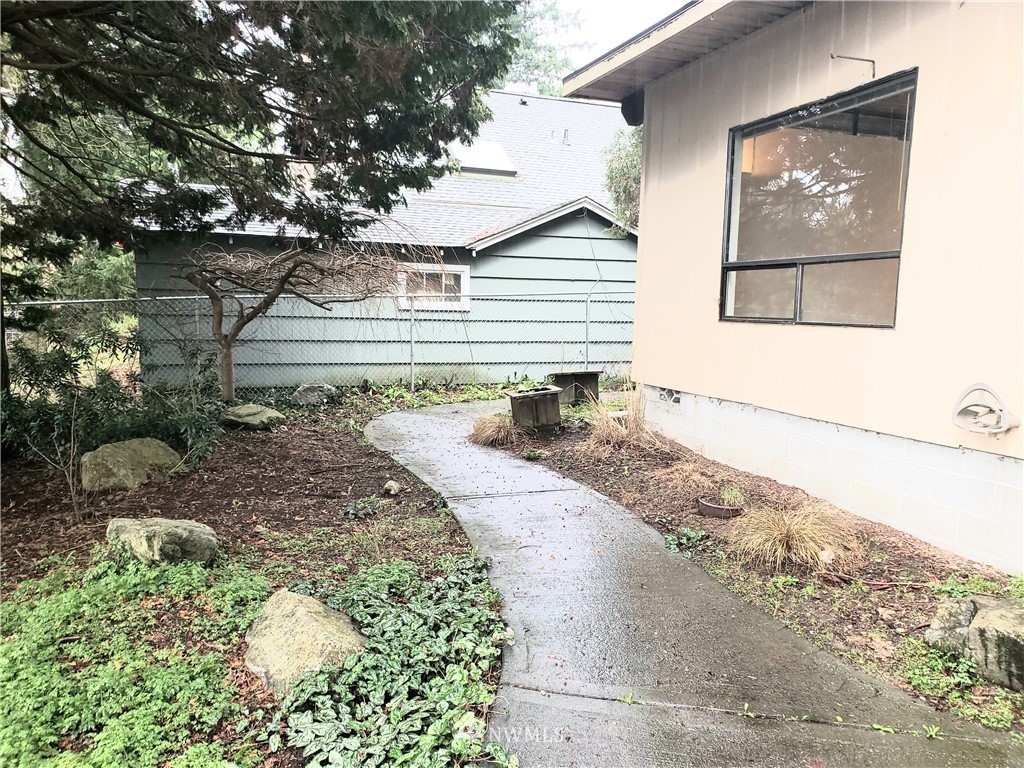 8690 Illahee Road Northeast Bremerton, WA 98311 - Photo 18 of 40 a front view of a house with garden