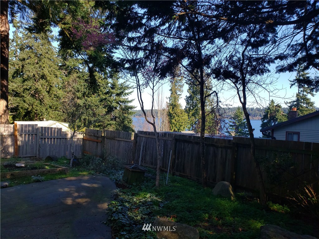 8690 Illahee Road Northeast Bremerton, WA 98311 - Photo 20 of 40 a backyard of a house with lots of green space