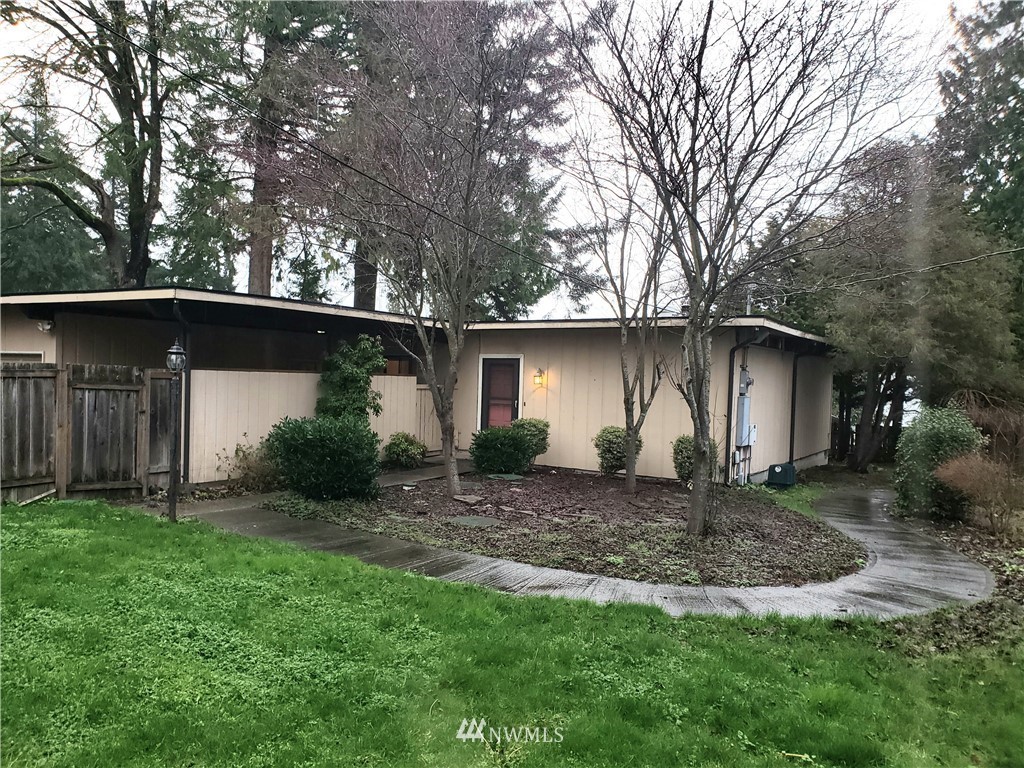 8690 Illahee Road Northeast Bremerton, WA 98311 - Photo 3 of 40 a view of a house with a yard and large tree