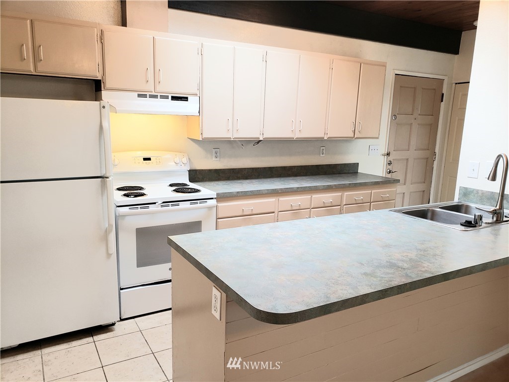 8690 Illahee Road Northeast Bremerton, WA 98311 - Photo 25 of 40 a kitchen with white cabinets and white appliances