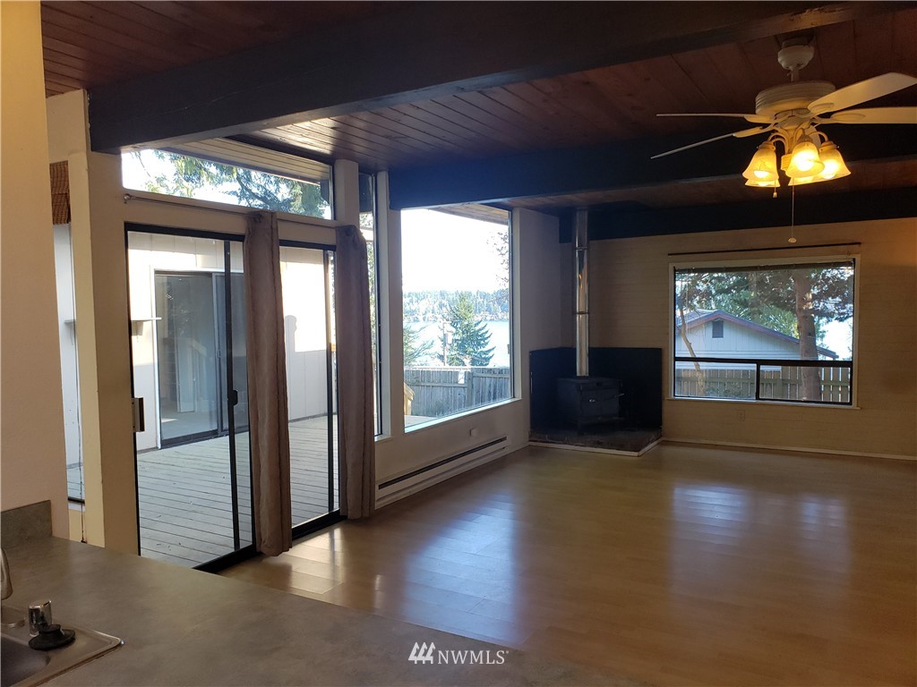 8690 Illahee Road Northeast Bremerton, WA 98311 - Photo 27 of 40 a view of gallery with floor to ceiling window and wooden floor