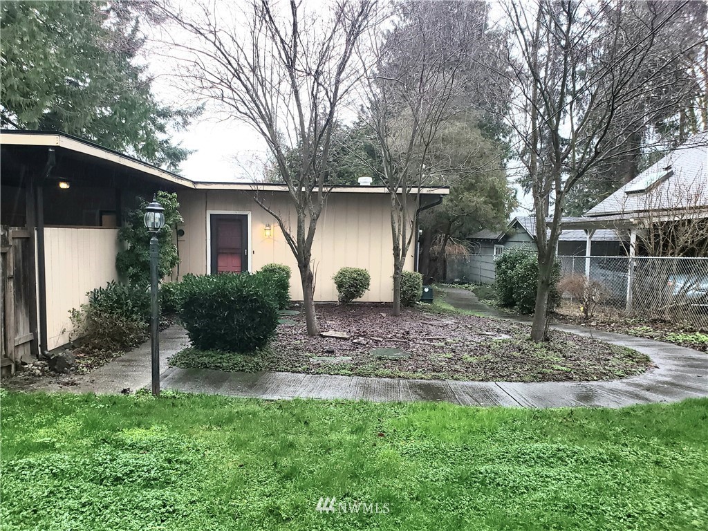 8690 Illahee Road Northeast Bremerton, WA 98311 - Photo 4 of 40 a view of a house with backyard and a tree