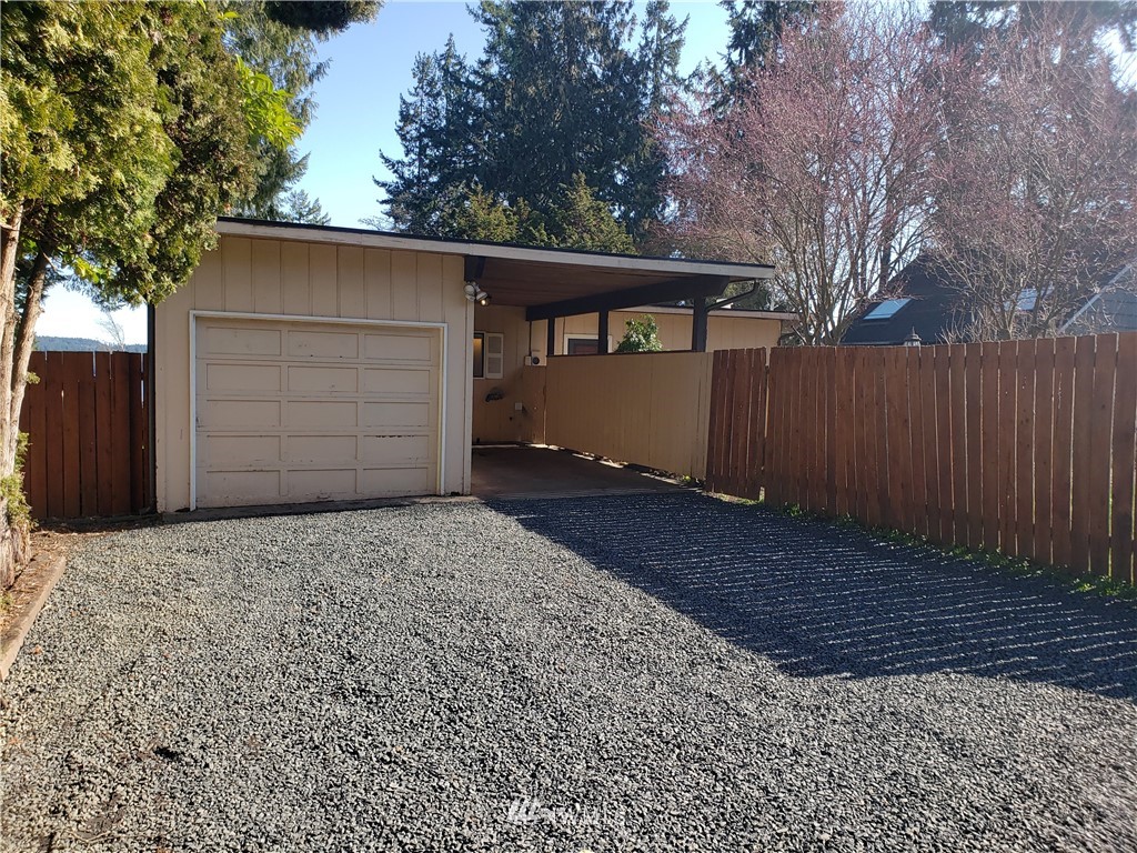 8690 Illahee Road Northeast Bremerton, WA 98311 - Photo 40 of 40 a front view of a house with a yard and garage