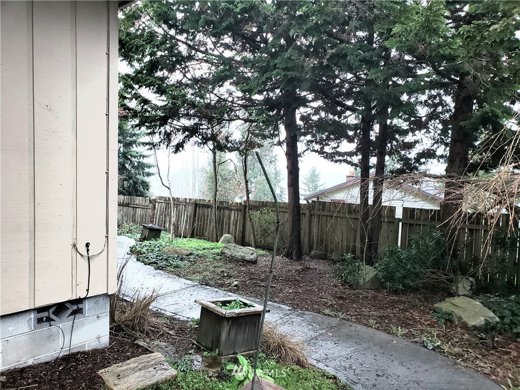 8690 Illahee Road Northeast Bremerton, WA 98311 - Photo 10 of 40 a view of a backyard with plants and trees