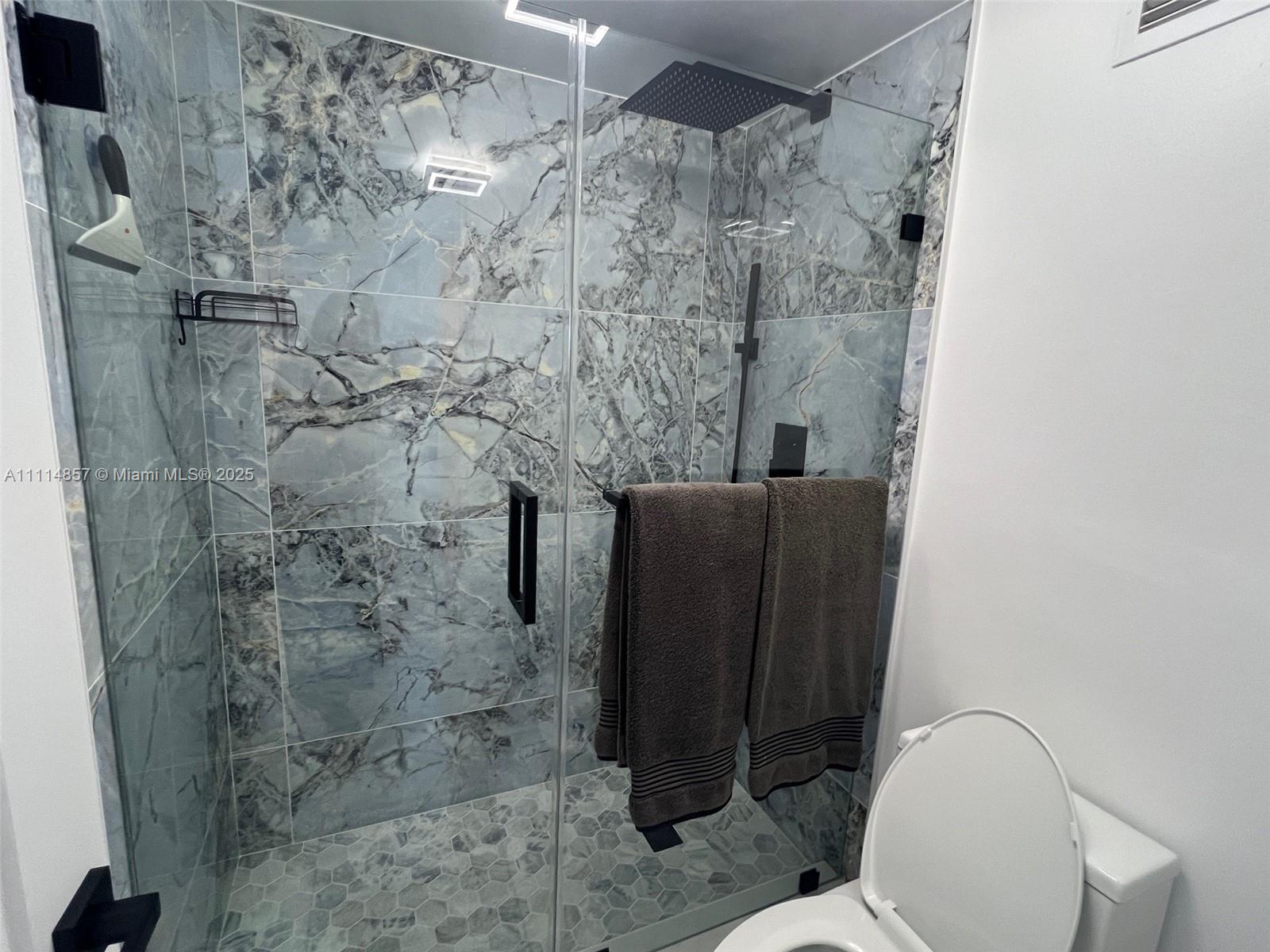 100 Lincoln Road, Unit 1207 Miami Beach, FL 33139 - Photo 11 of 54 a bathroom with a shower and toilet
