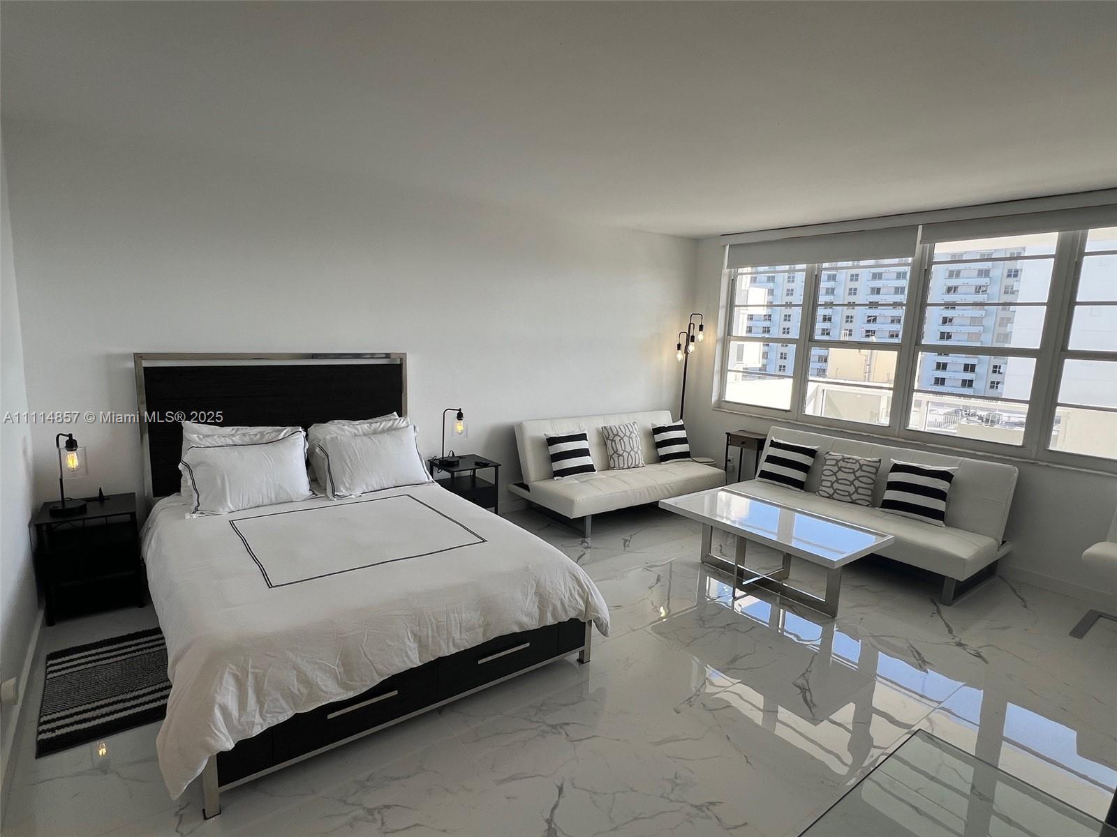 100 Lincoln Road, Unit 1207 Miami Beach, FL 33139 - Photo 14 of 54 a spacious bedroom with a bed and a couch