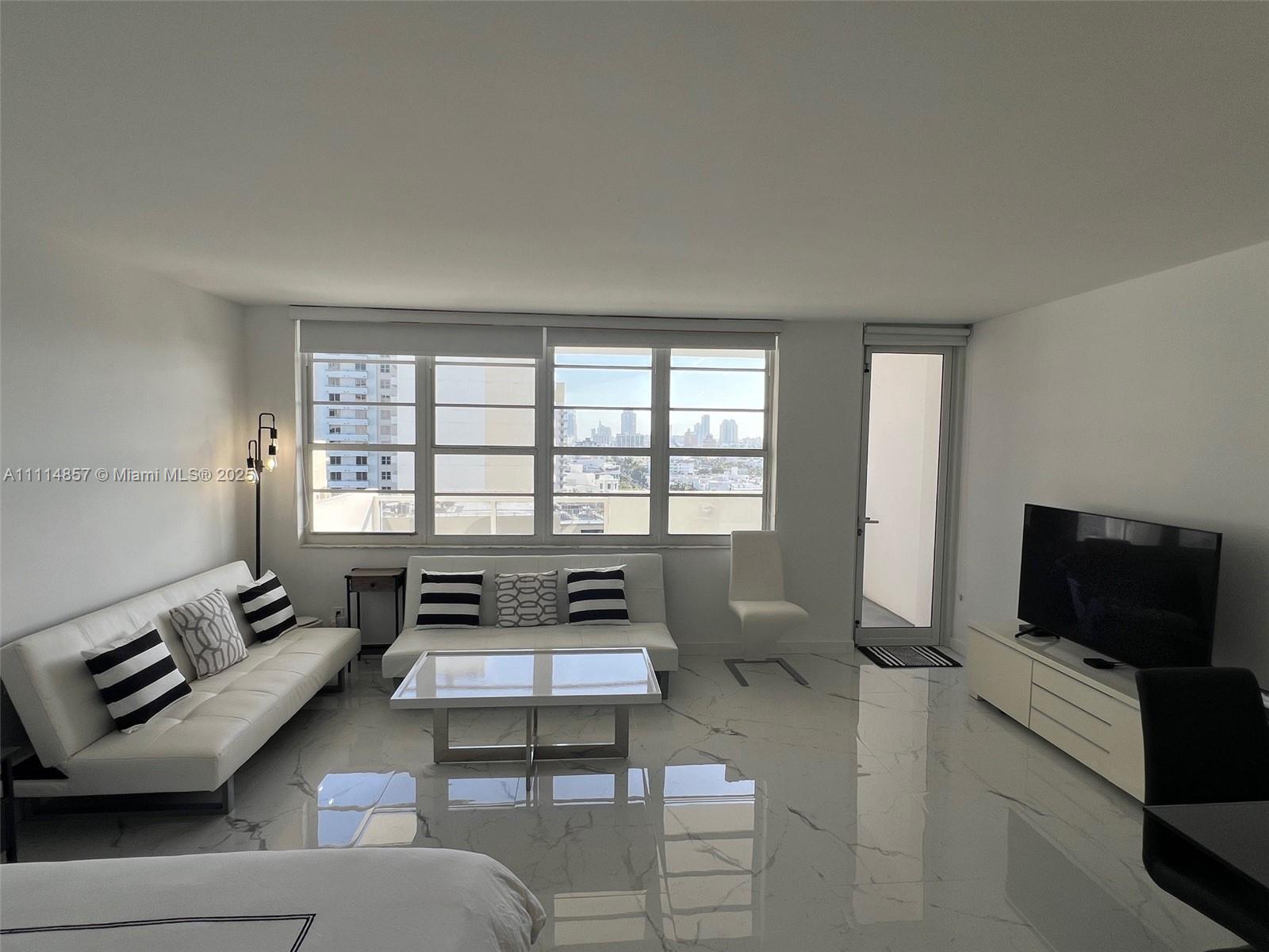 100 Lincoln Road, Unit 1207 Miami Beach, FL 33139 - Photo 4 of 54 a living room with furniture and a flat screen tv