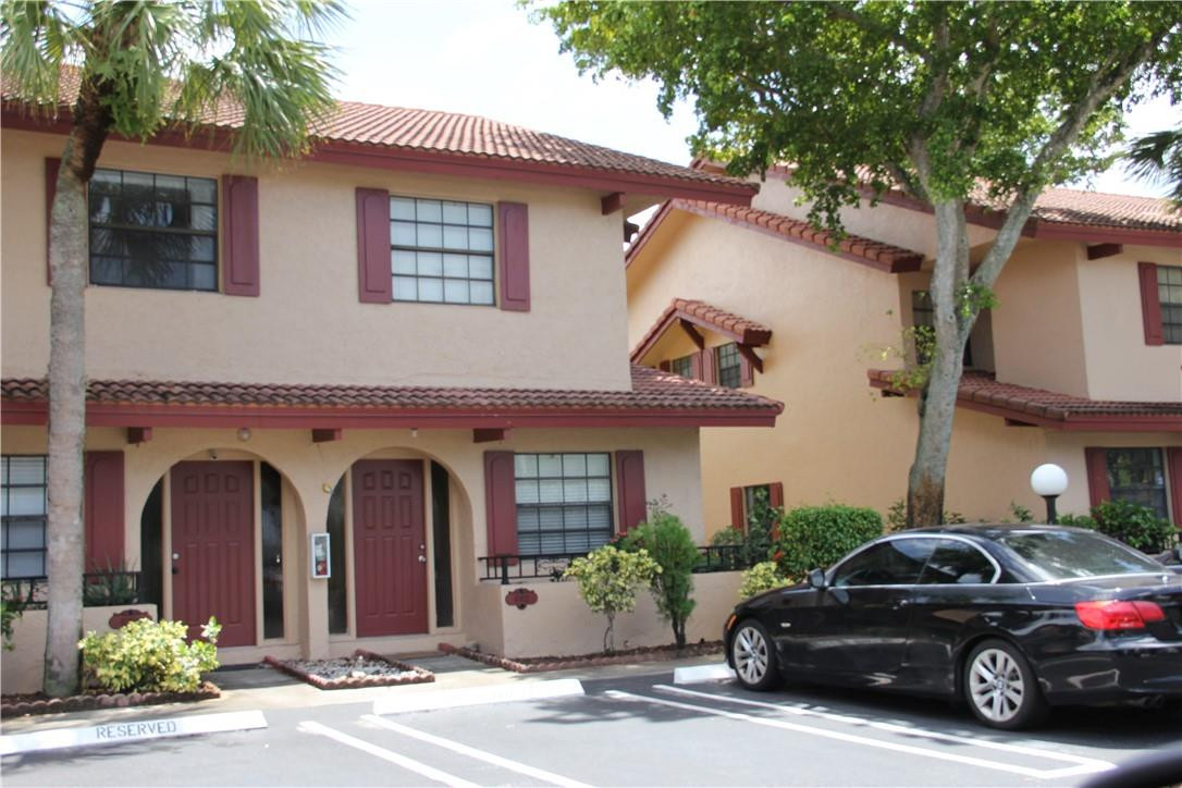 10932 West Sample Road, Unit F2 Coral Springs, FL 33065 - Photo 1 of 23 a view of a car parked in front of a house