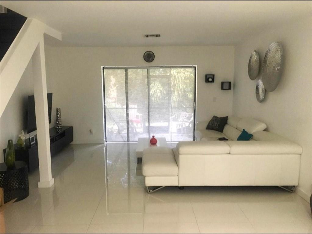 10932 West Sample Road, Unit F2 Coral Springs, FL 33065 - Photo 4 of 23 a living room with furniture and a large window