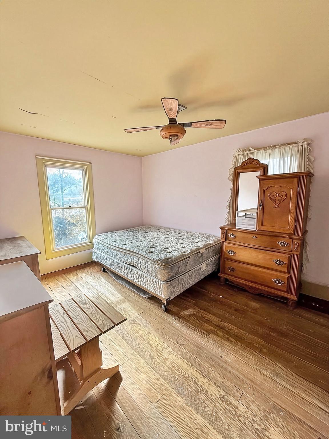 86 Lynn Street Madera, PA 16661 - Photo 11 of 13 a bedroom with a bed and wooden floor