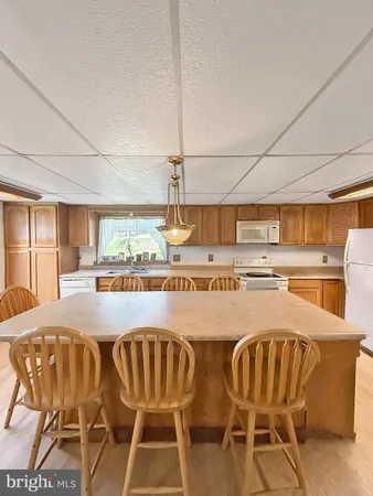 a view of a kitchen with dining area windows and kitchen view