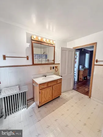 a spacious bedroom with a bed and dresser