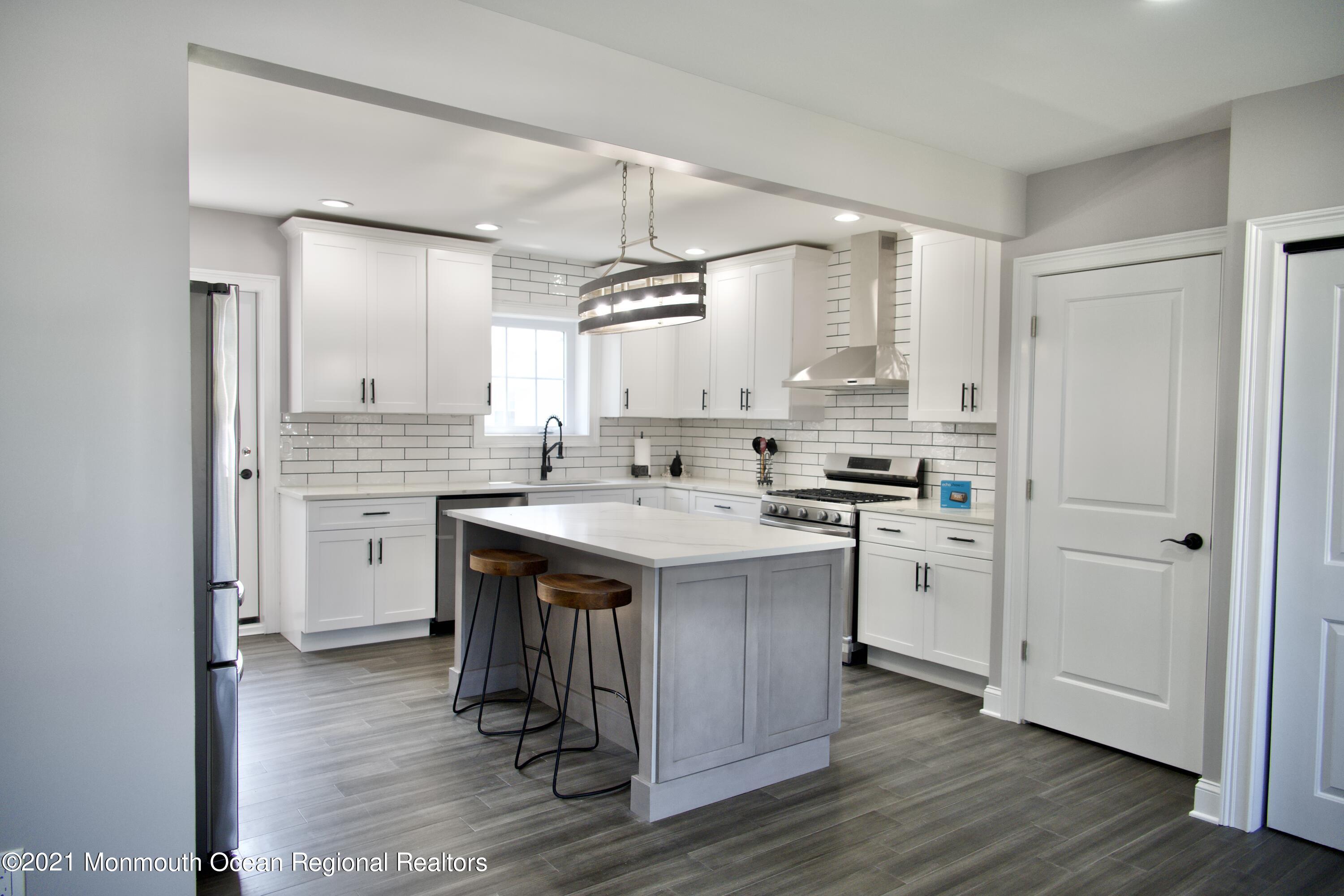 2230 Rogers Road Point Pleasant, NJ 08742 - Photo 14 of 51 a kitchen with a sink cabinets stainless steel appliances and a window