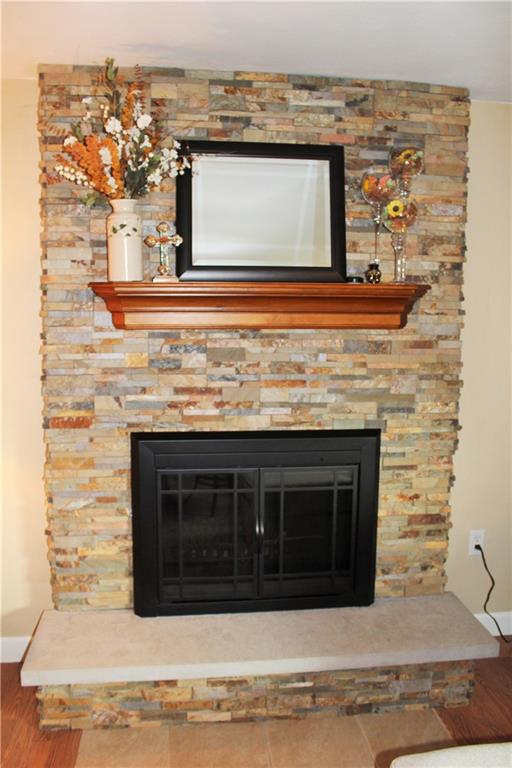 1107 Countryside Drive McKees Rocks, PA 15136 - Photo 13 of 25 Log burning fireplace has been completely refaced with stone, new mantle, screen and flooring.