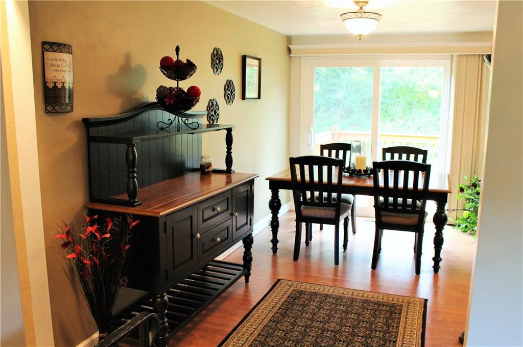 Off the dining room there is a newer sliding glass door which leads to a new deck.  Easy access to outside living space overlooking well manicured yard.  