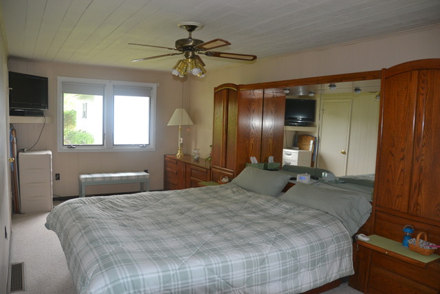 636 Reynoldswood Road Dixon, IL 61021 - Photo 13 of 25 a bedroom with a bed and a chandelier