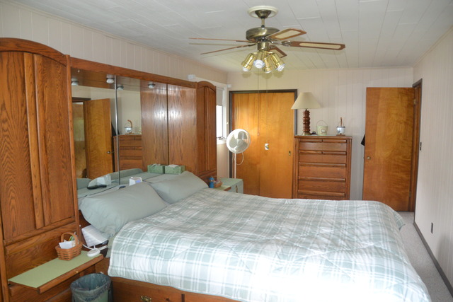 636 Reynoldswood Road Dixon, IL 61021 - Photo 14 of 25 a bedroom with a bed and a chandelier