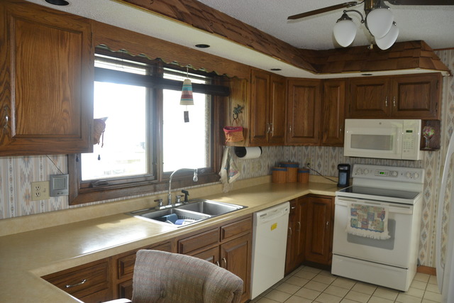636 Reynoldswood Road Dixon, IL 61021 - Photo 4 of 25 a kitchen with a sink stove and cabinets