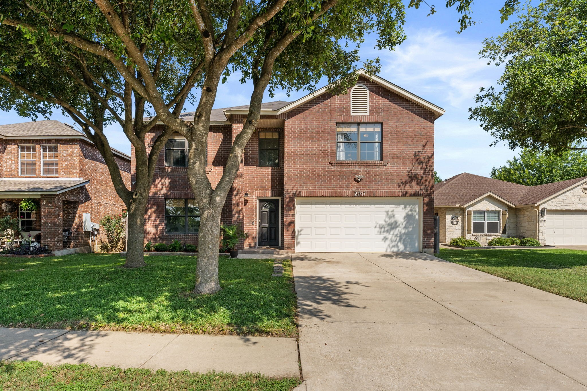 2017 Cyclone Ridge Cove Round Rock, TX 78665 - Photo 1 of 1 a front view of a house with a yard and trees