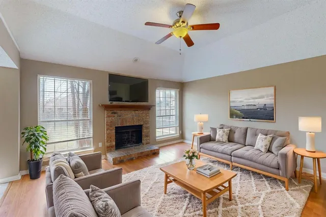 a living room with furniture a fireplace and a flat screen tv