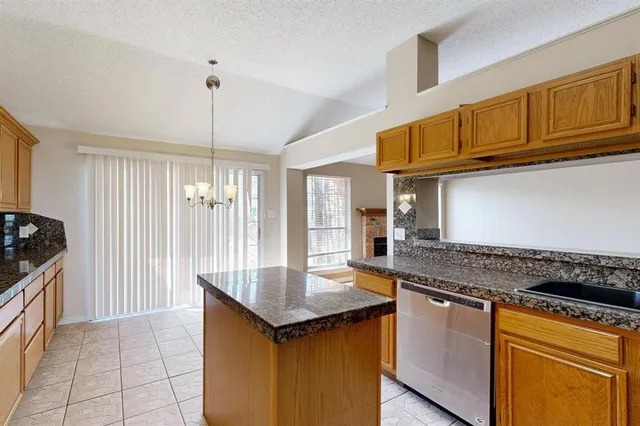 a kitchen with stainless steel appliances granite countertop a sink and cabinets