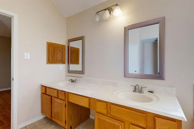 a bathroom with 2 sink and a mirror