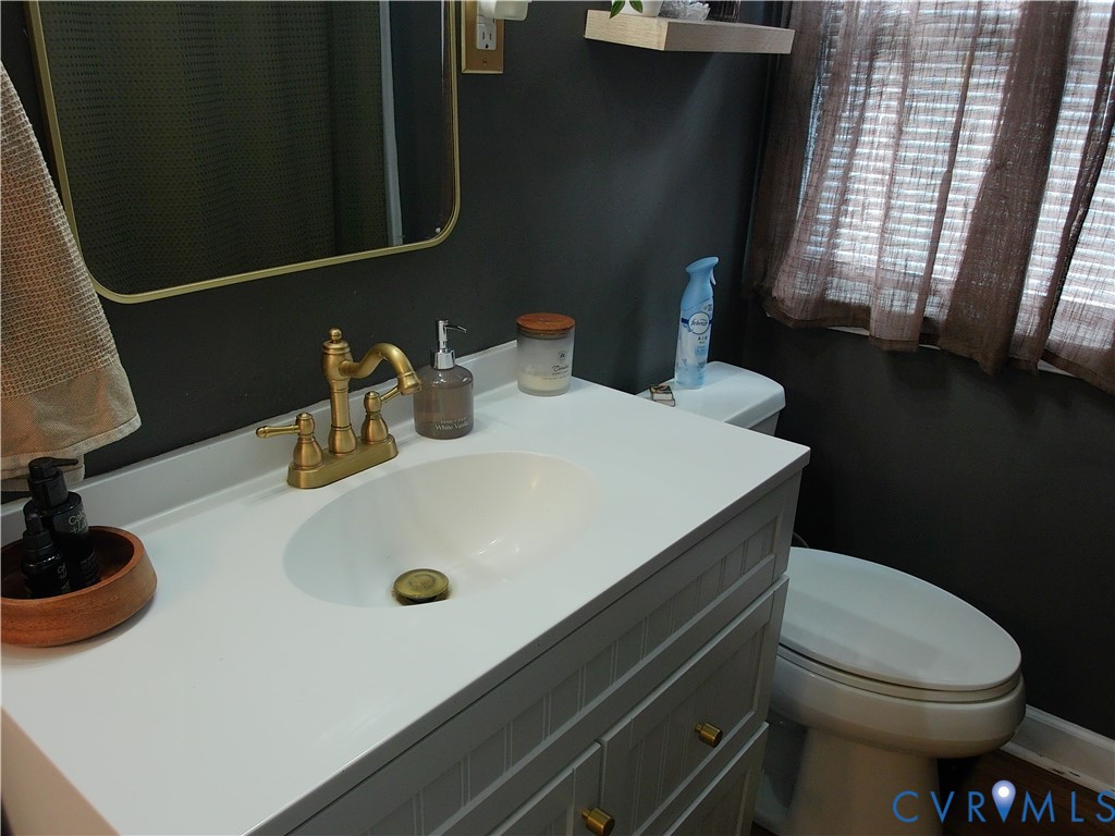 3284 Chickahominy Road Toano, VA 23168 - Photo 22 of 26 Vanity with white countertop, integrated sink, and