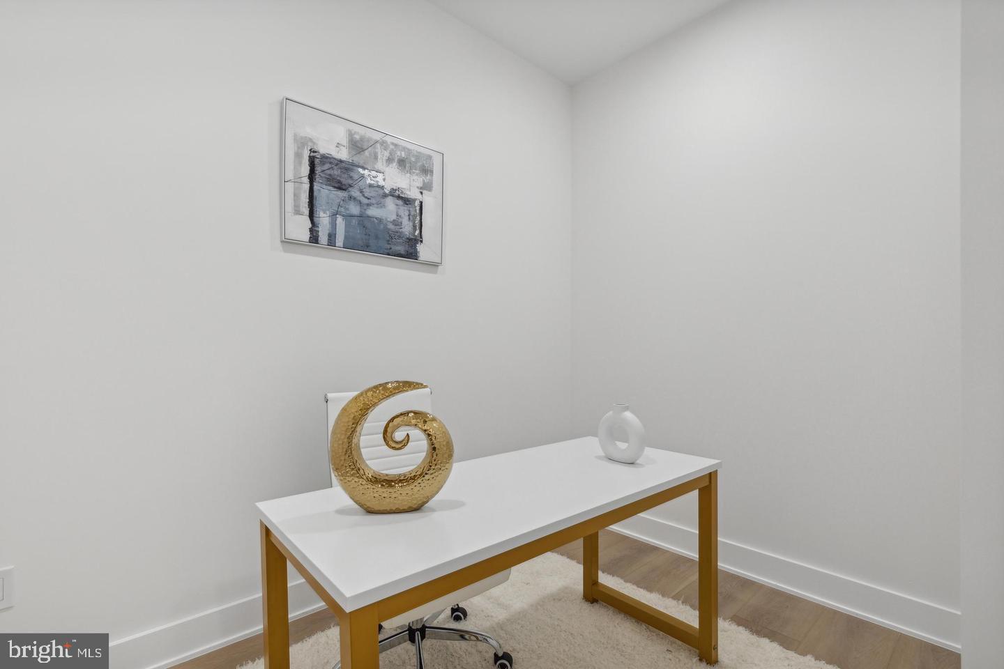 705 Quincy Street Northeast, Unit 2 Washington, DC 20017 - Photo 12 of 15 a view of a room that has a table and a chair