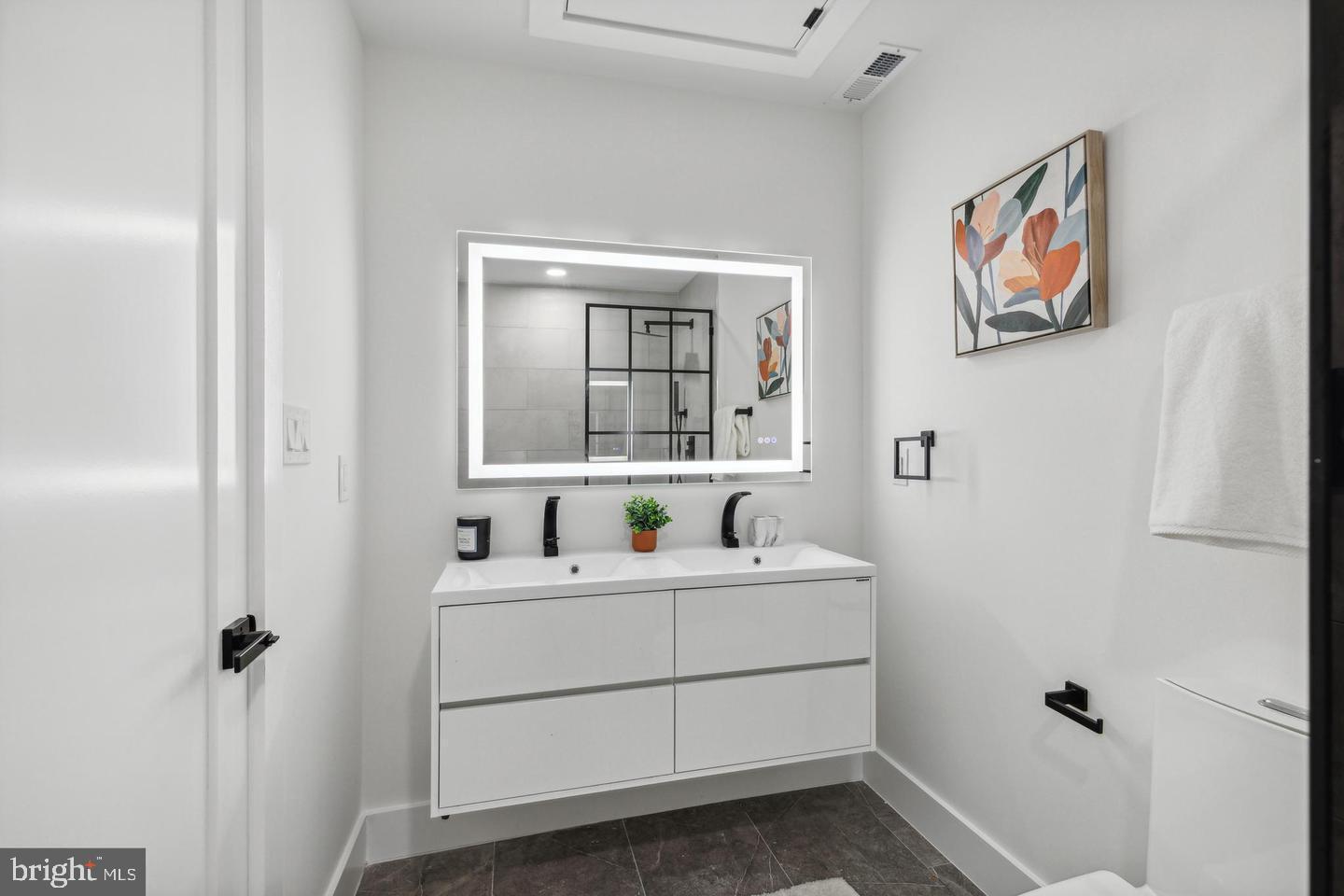 705 Quincy Street Northeast, Unit 2 Washington, DC 20017 - Photo 7 of 15 a bathroom with a sink and a mirror