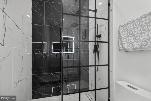 a bathroom with a glass door shower