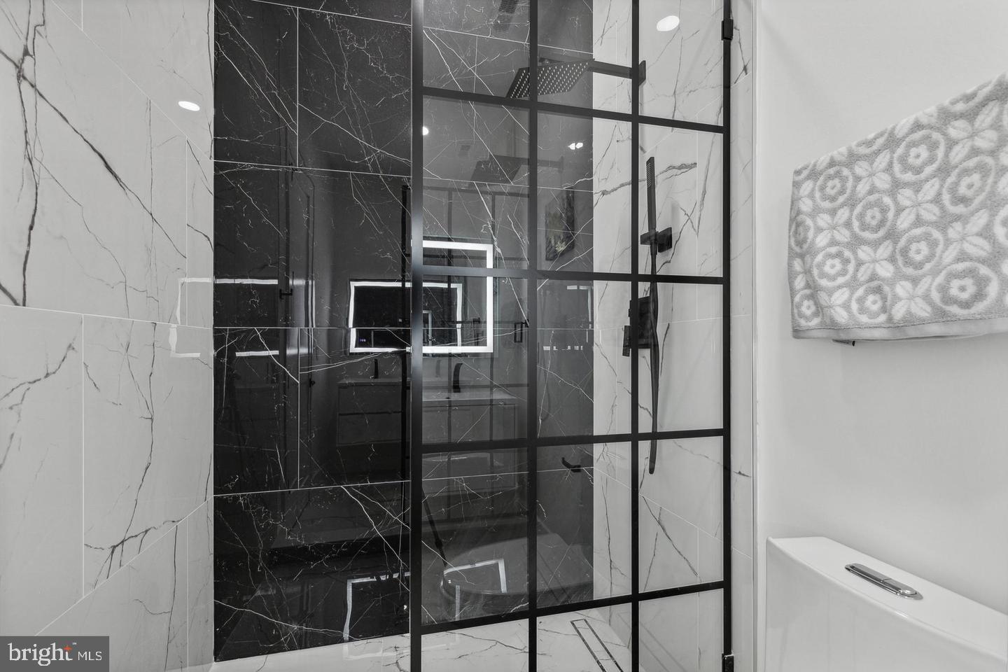 705 Quincy Street Northeast, Unit 2 Washington, DC 20017 - Photo 8 of 15 a bathroom with a glass door shower