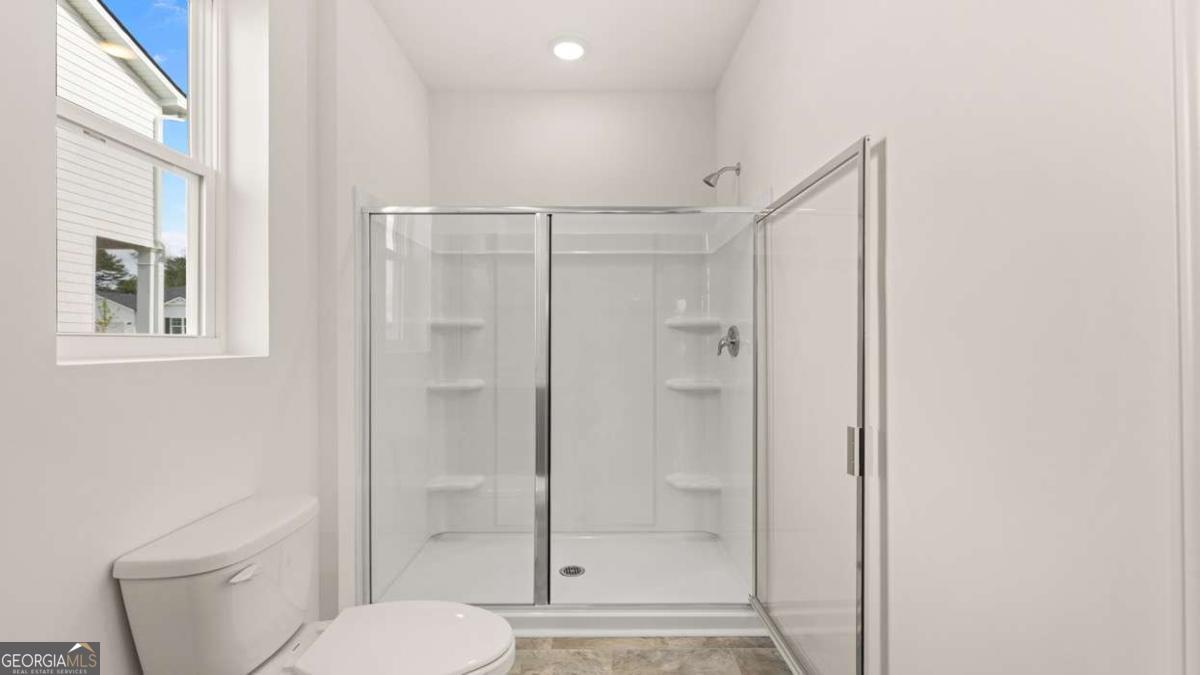 8576 Seabiscuit Road Lithonia, GA 30058 - Photo 15 of 22 a bathroom with a shower a toilet and a sink
